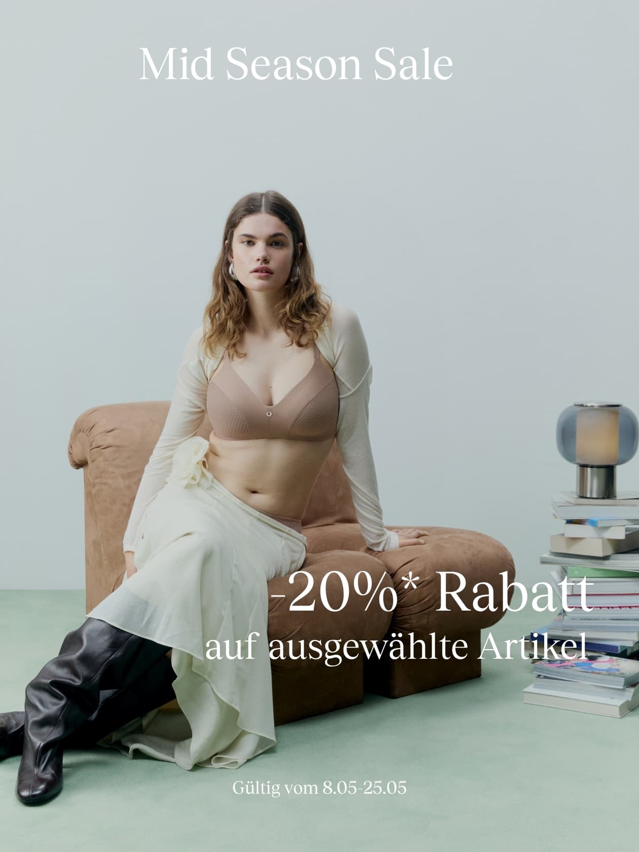 Woman in a beige outfit sits on a sofa for a mid-season sale ad offering 20% off selected items, valid from May 8th to 25th.