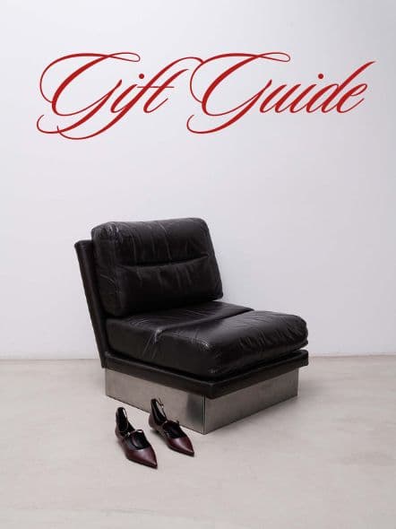 A sleek black leather lounge chair and a pair of pointed heels set the tone for a sophisticated holiday gift guide.