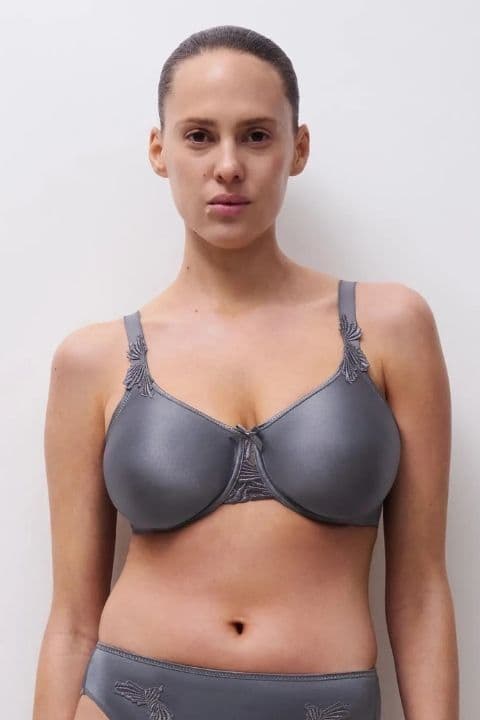 Person in a gray satin bra and matching underwear, standing against a plain white background.