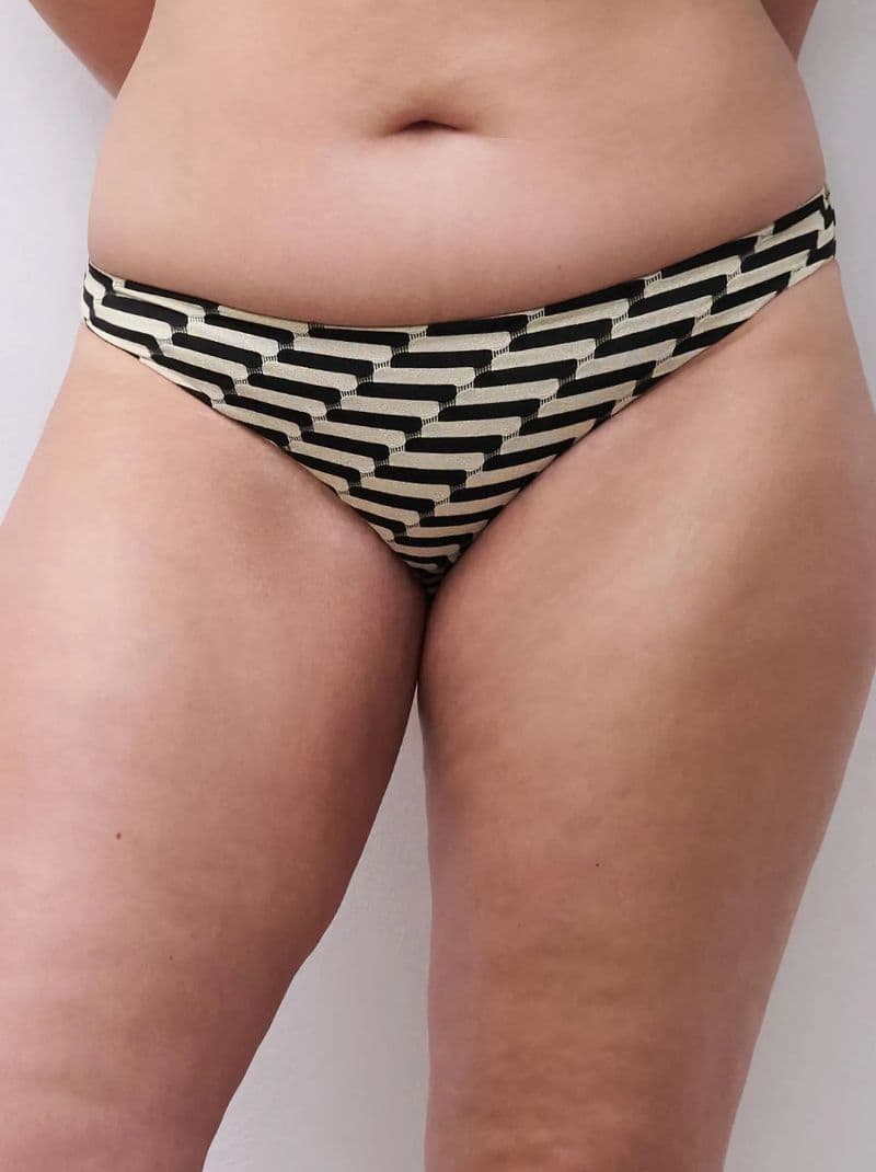 Close-up of a person wearing black and white patterned bikini bottoms with a zigzag design.