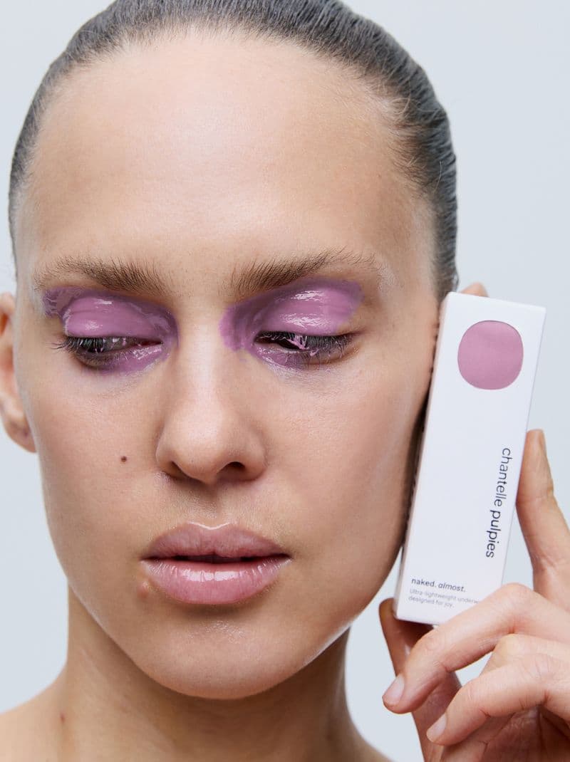 Person with pink eye makeup holding a box labeled "chantelle pulpies" close to their face, showcasing a beauty product.