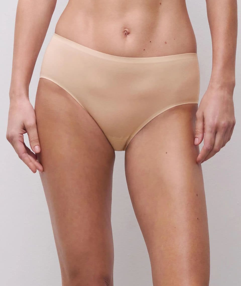 Person wearing seamless nude-colored underwear against a plain background. The underwear has a smooth, stretchy fabric for a comfortable fit.