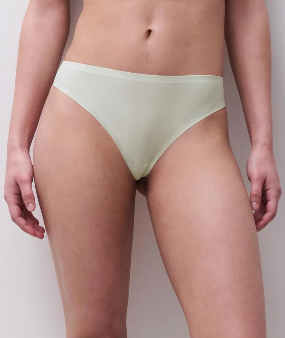 A person models light seamless underwear against a neutral background.