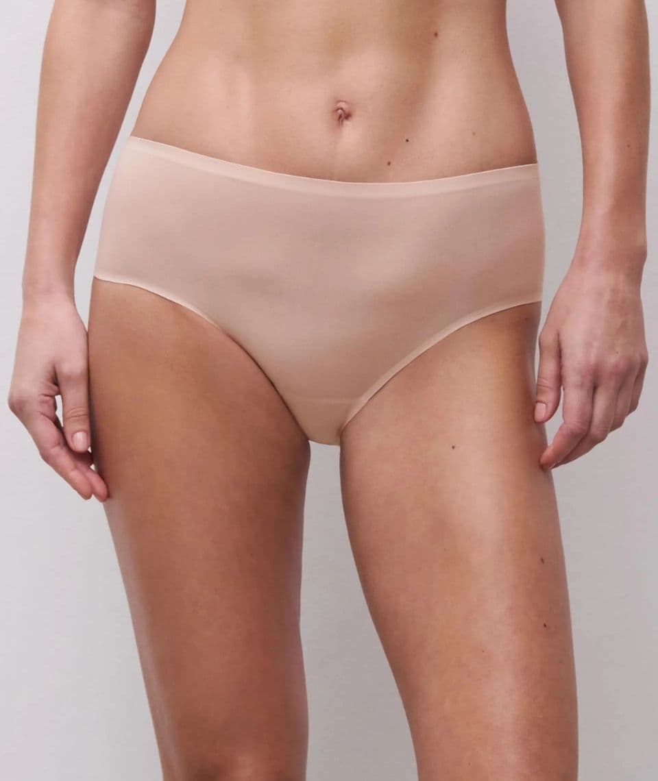Person wearing seamless soft pink-colored underwear, showcasing a smooth and comfortable fit.