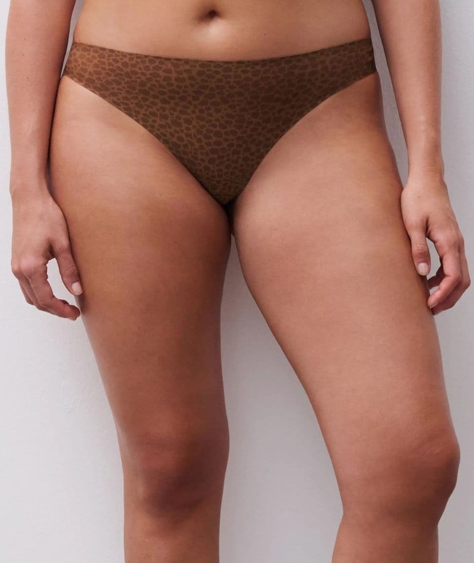 Person wearing brown leopard print underwear, shown from the waist to mid-thigh against a plain white background.