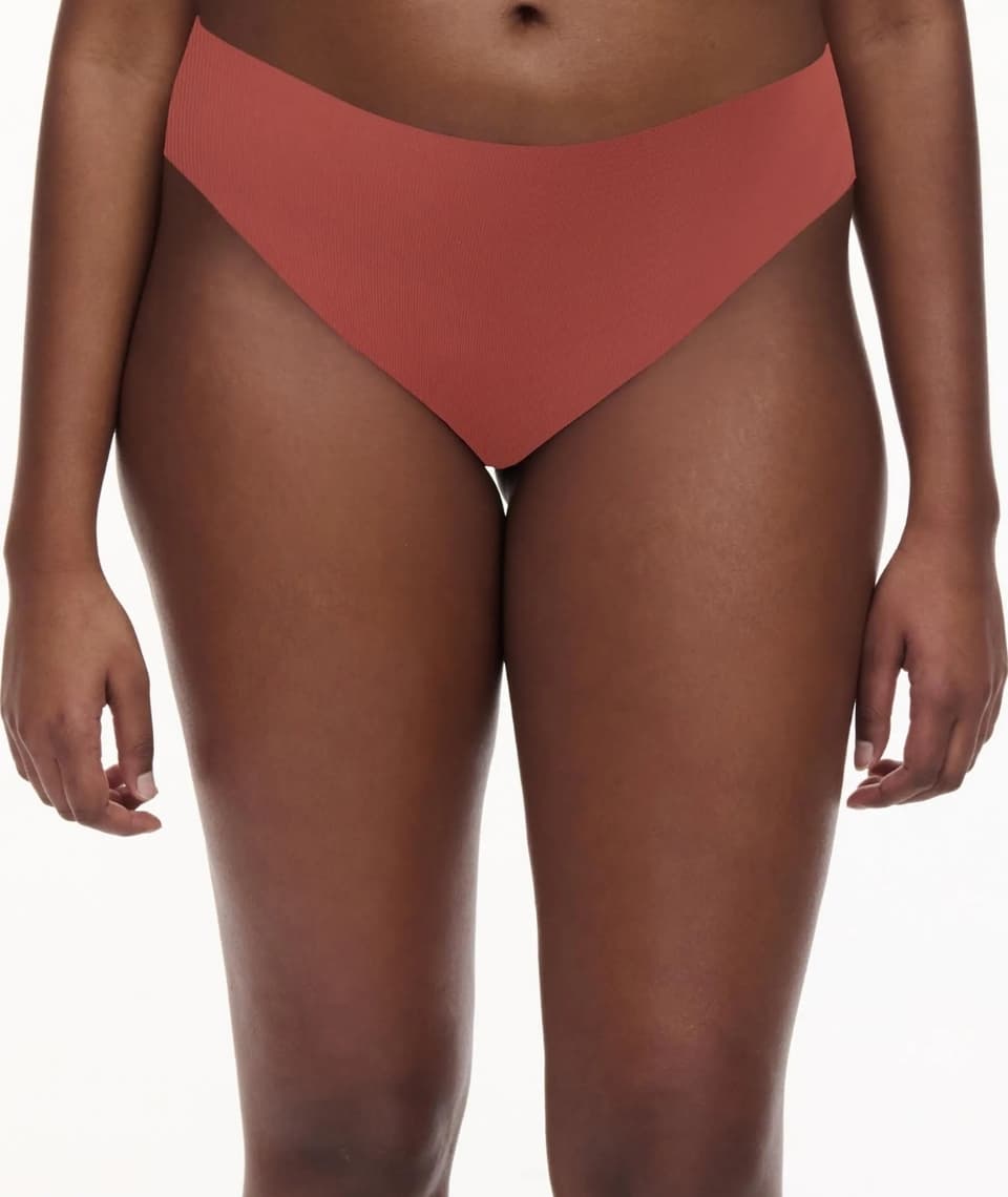 Person wearing high-waisted colored bottoms, shown from waist to mid-thigh against a white background.