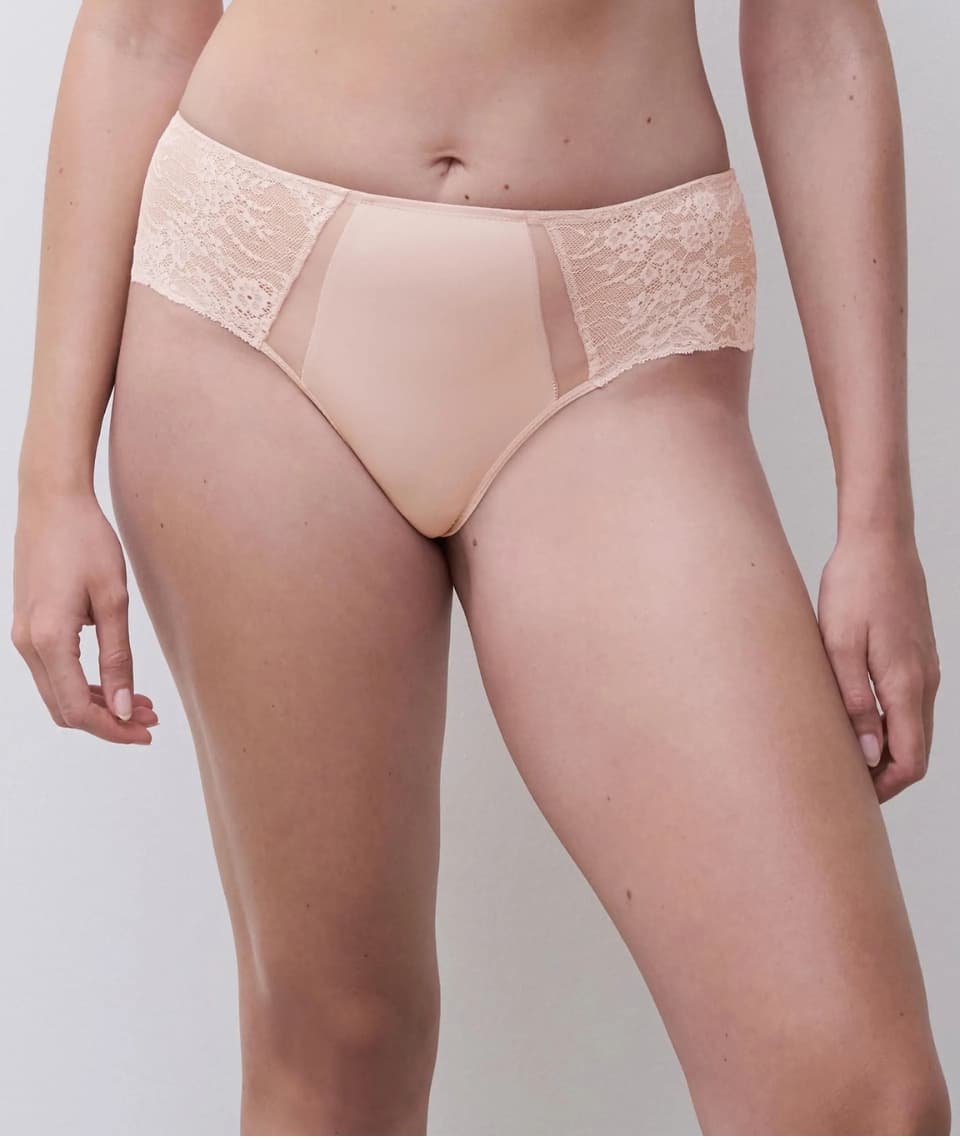 A person wearing a lace-trimmed underwear, shown from waist to mid-thigh against a neutral background.