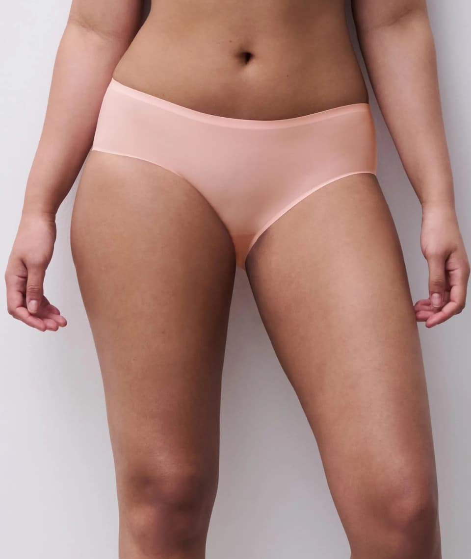 A person wearing light pink seamless underwear, shown from the waist to the thighs against a plain background.