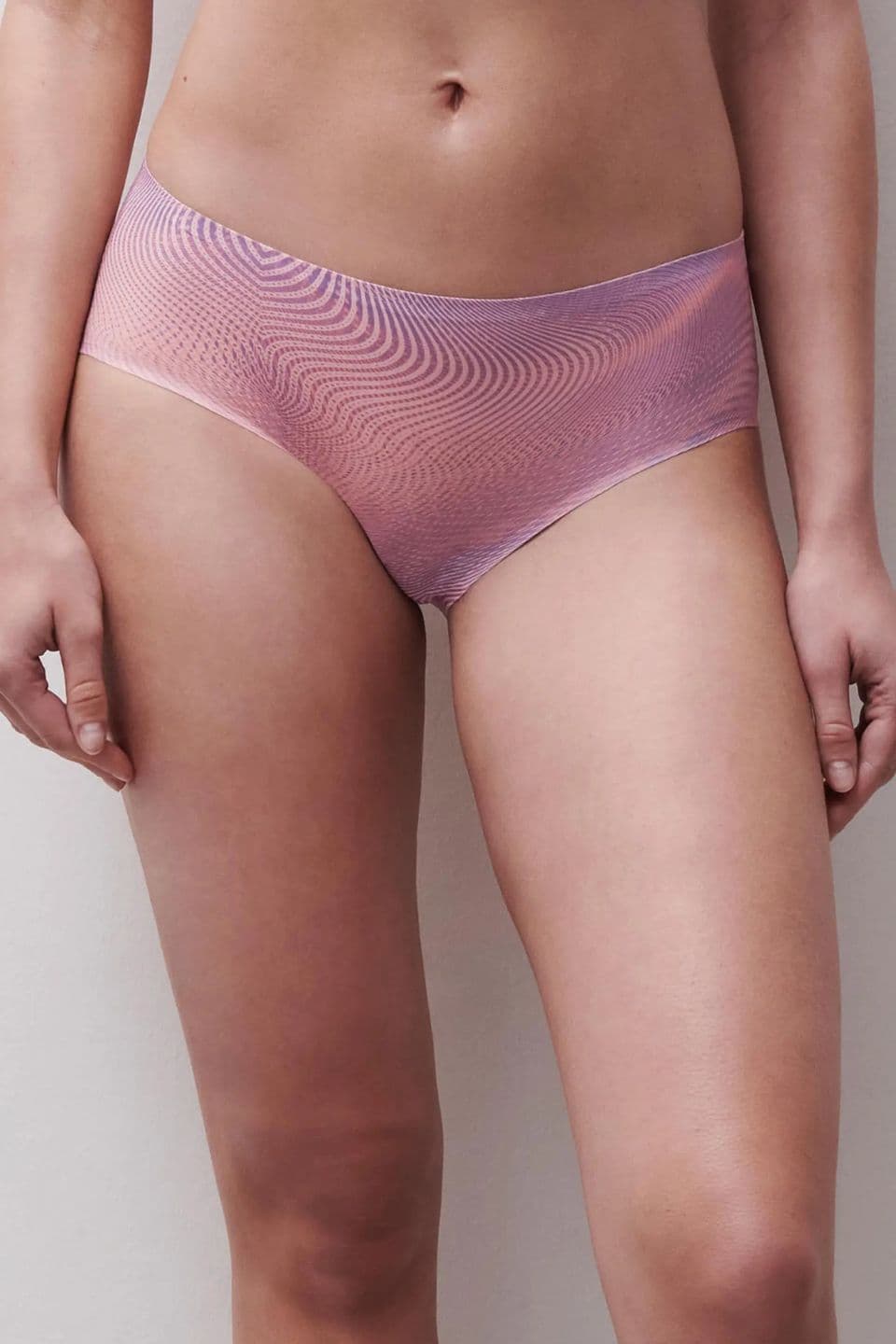 Mid-rise seamless panties in a soft pink shimmer, offering a smooth fit with a subtle, modern wave pattern.