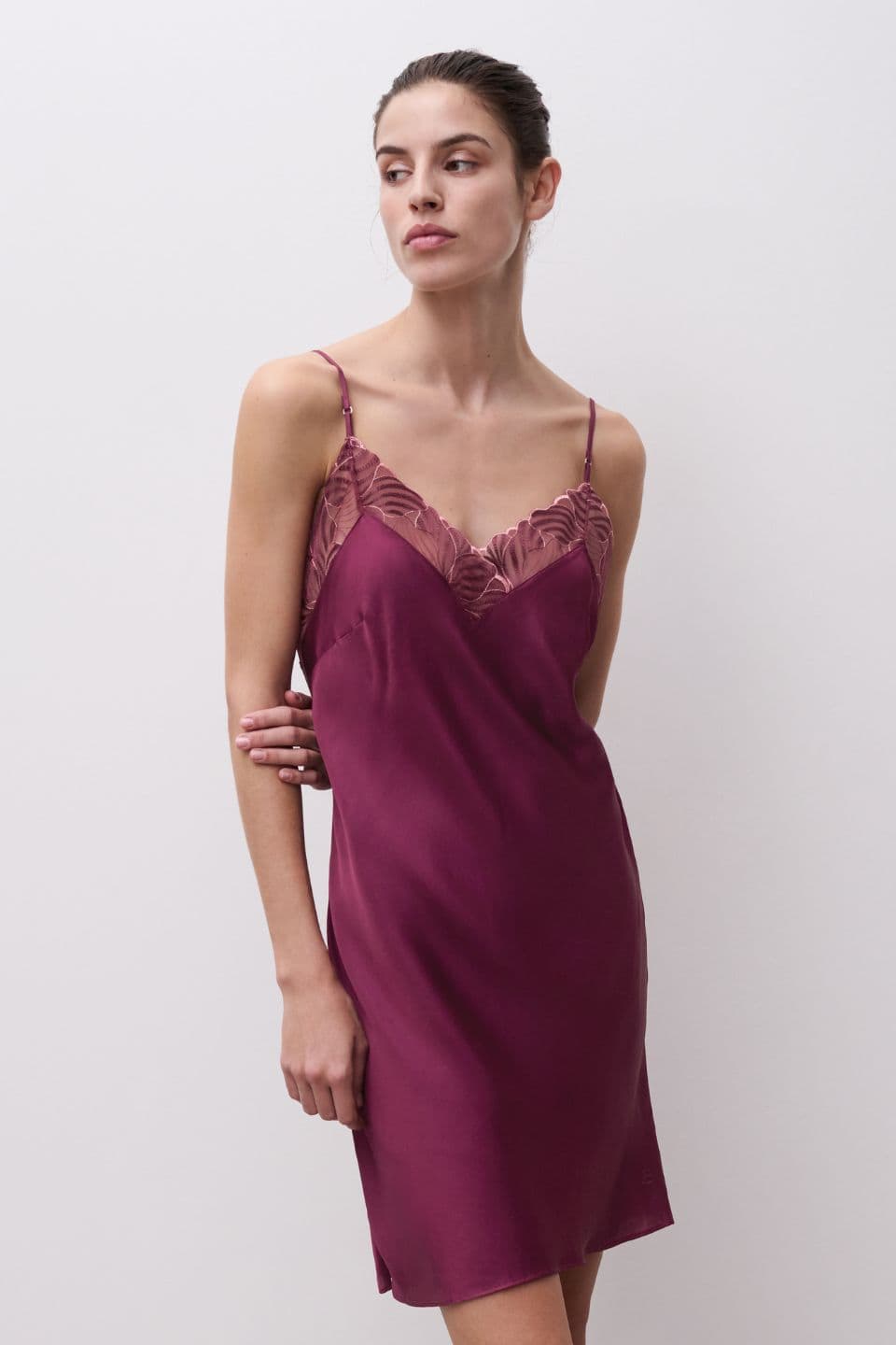 A woman is seen wearing a nightdress in the color sienna.