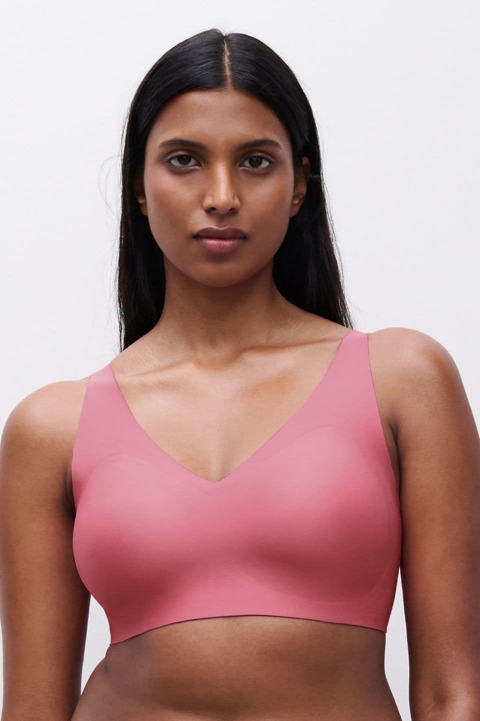 The image shows a woman wearing a pink wireless SoftStretch Power bra.