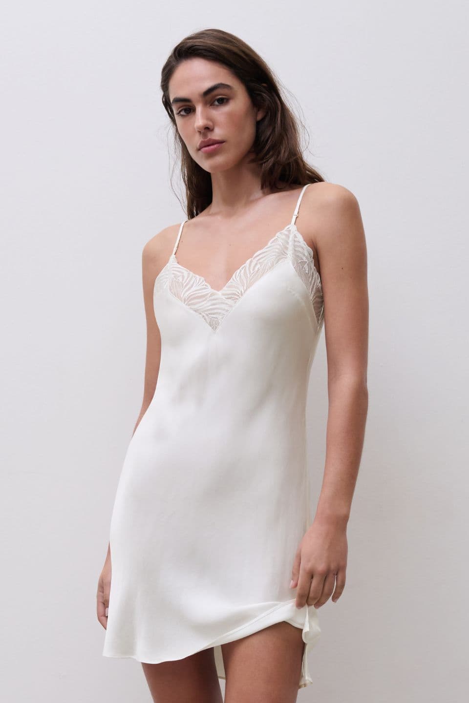 A woman is seen wearing a nightdress in milk.