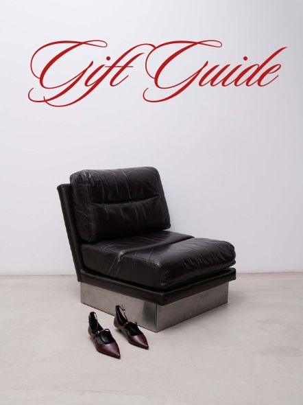 A sleek black leather lounge chair and a pair of pointed heels set the tone for a sophisticated holiday gift guide.