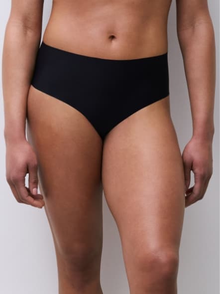Person wearing high-waisted, black seamless underwear against a plain white background.