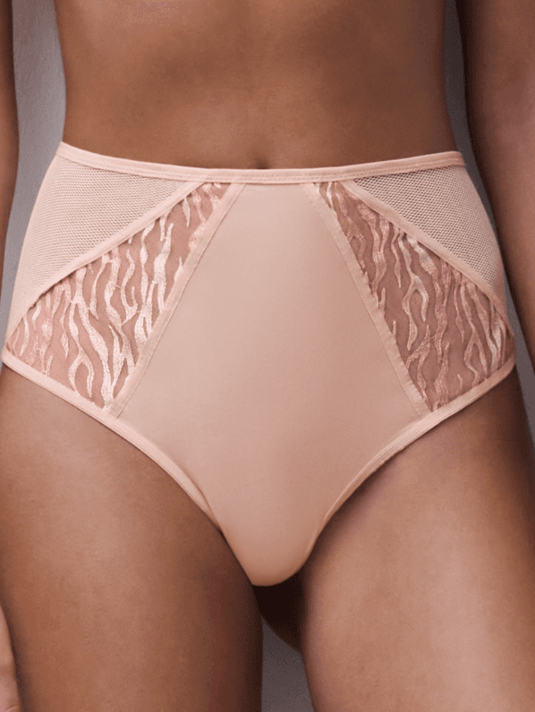 A model wearing high-waisted beige lingerie with lace detailing and mesh panels, showcasing a delicate design.